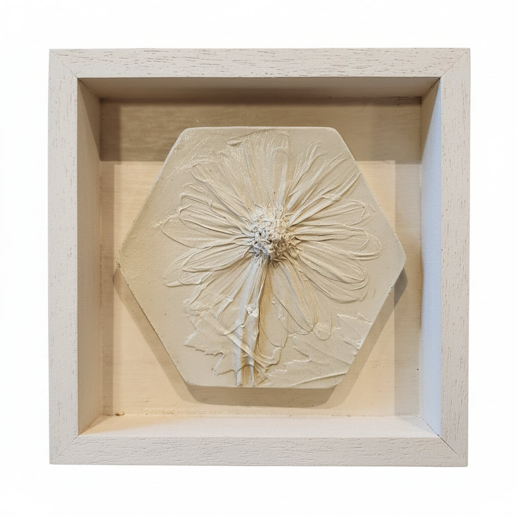 Hexagonal plaster cast of a daisy in a 5"×5"×1" wooden frame in white finish
