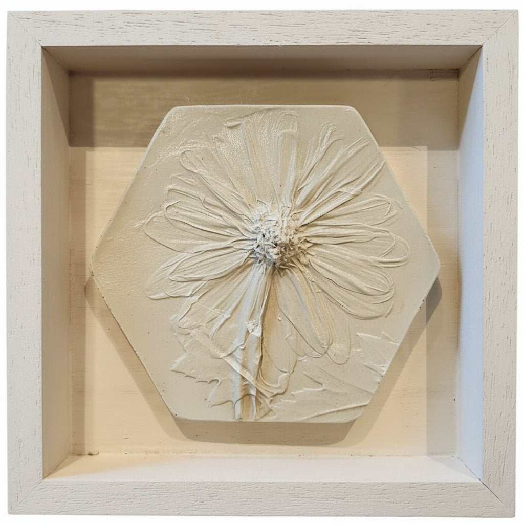 Hexagonal plaster cast of a daisy in a 5"×5"×1" wooden frame in white finish