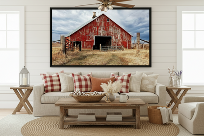 Living room with a large framed picture of a red barn on the wall.