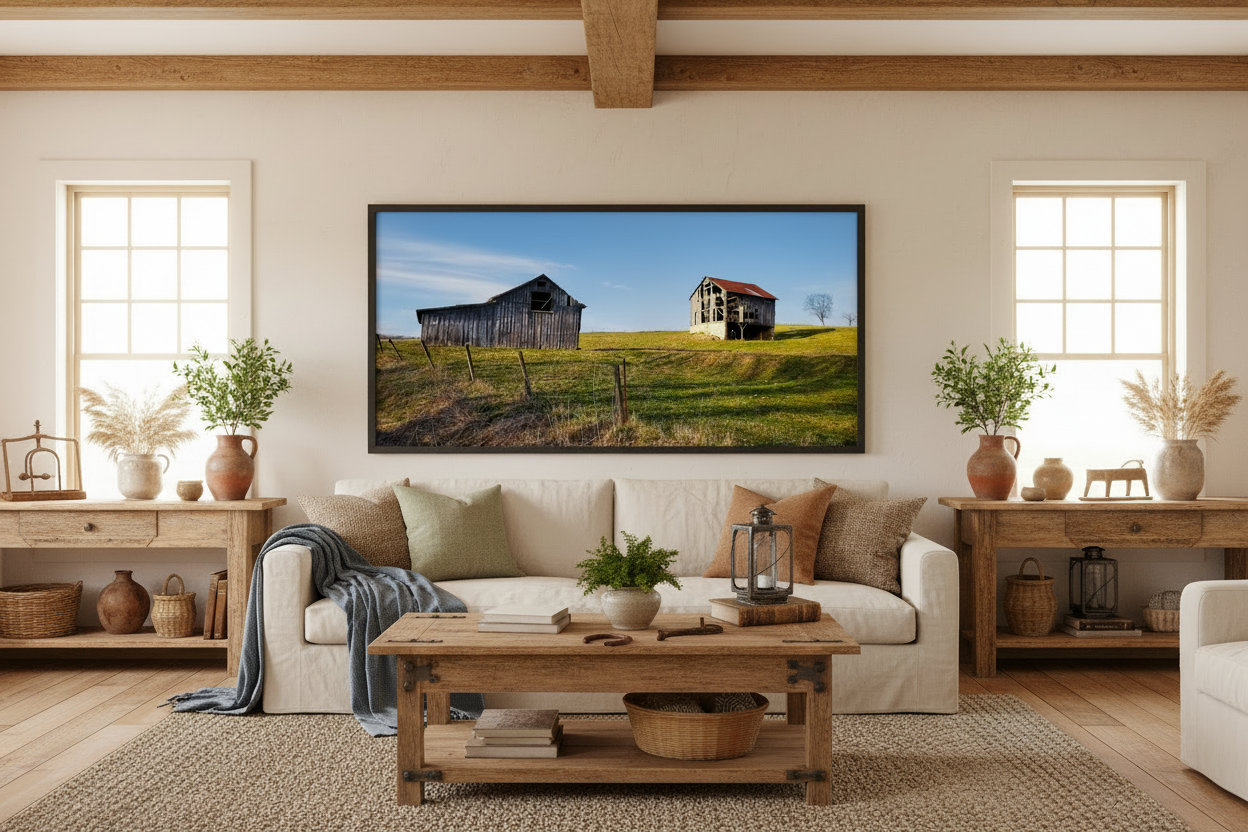 Living room with a large framed photo print of two barns on the wall, wooden coffee table, and decorative items.