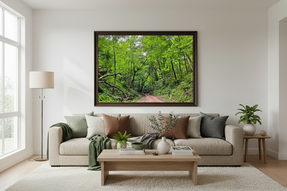 Living room with a beige sofa, wooden coffee table, and a large framed picture of a forest.