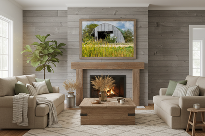Living room with a fireplace, couches, and a large photo print of a barn on the wall.