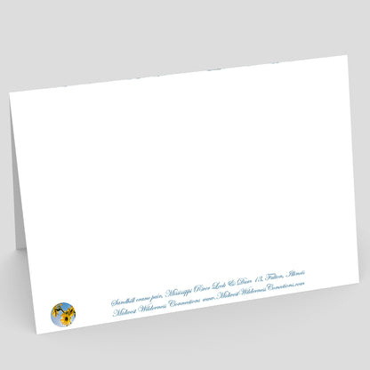 View of the backside of a White greeting card with blue text and a logo on a gray background. The text describes the photo on the front of the card and where the photo was taken.