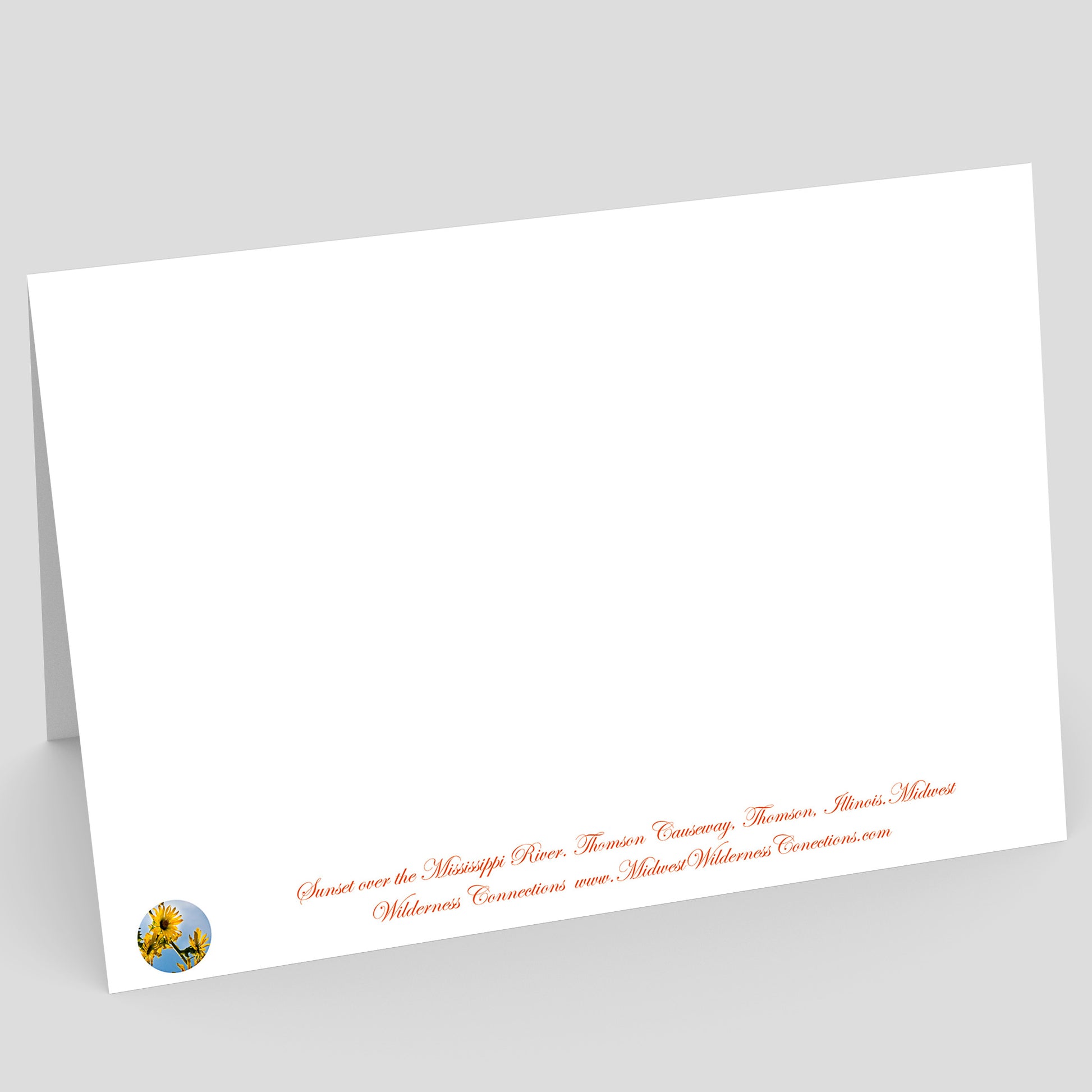 View of the backside of a White card with red text and a small logo on a gray background. the text along the bottom edge of the card describes the scene on the front and location where the photo was taken
