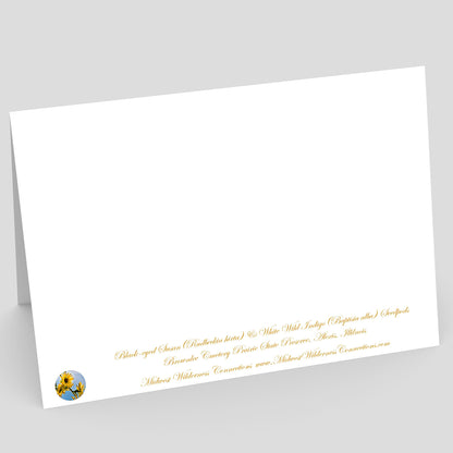 Backside view of a White card with gold text on a gray background. The text along the bottom edge describes the image on the front and where the photo was taken