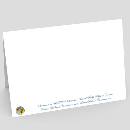 View of the backside of a white card with text and a logo on a gray background. The text along the bottom of the card provides information on the image on the front and where the photo was taken