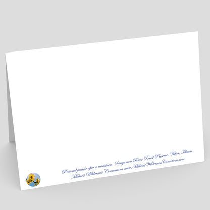 View of the backside of a White card with blue text and a logo on a gray background. The text along the bottom edge describes the image on the front of the card and where the photo was taken