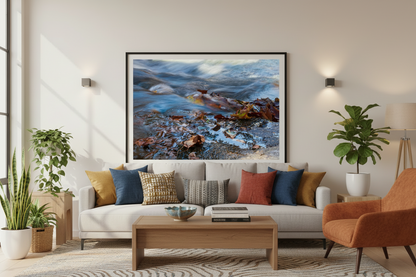 Framed photo print of a flowing stream and leaves displayed in a living room