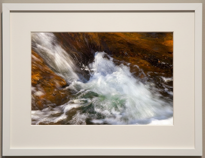 Framed photograph of a waterfall with a neutral background