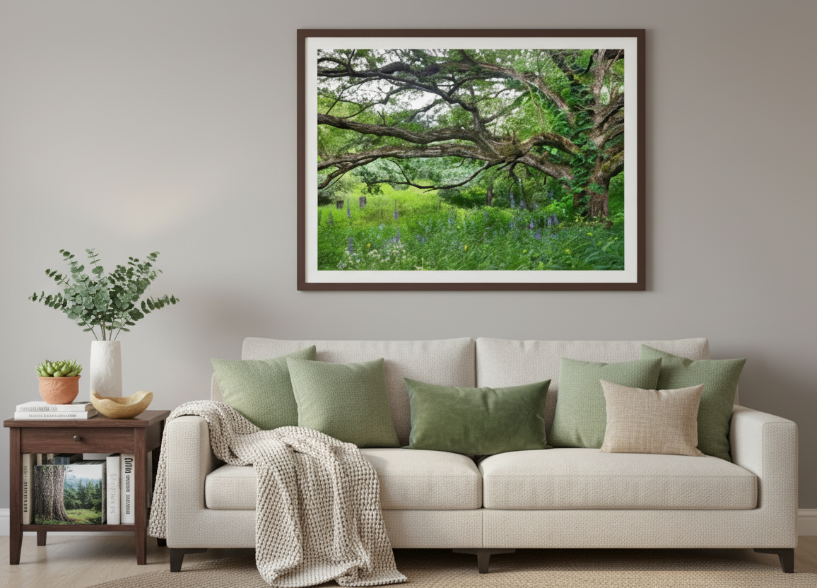 Living room with a beige sofa, decorative pillows, and a framed nature print on the wall.