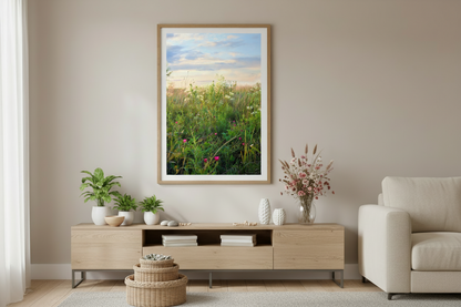 Framed artwork of a midwest prairie scene above a wooden TV stand in a living room.