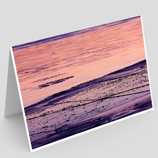 Greeting card with abstract design of a pink and purple sunset reflecting on mississippi river ice on a white background