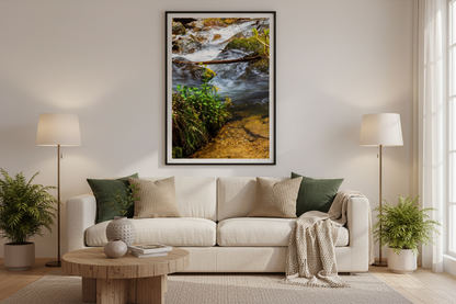 Living room with beige sectional sofa, wooden coffee table, and framed nature print of a flowing stream on the wall.