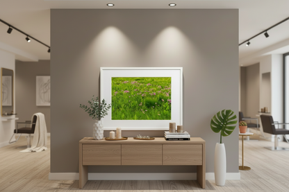 Frame photo print , featuring native prairie wildflowers hanging in a Modern interior with a wooden console table and decorative items against a gray wall.