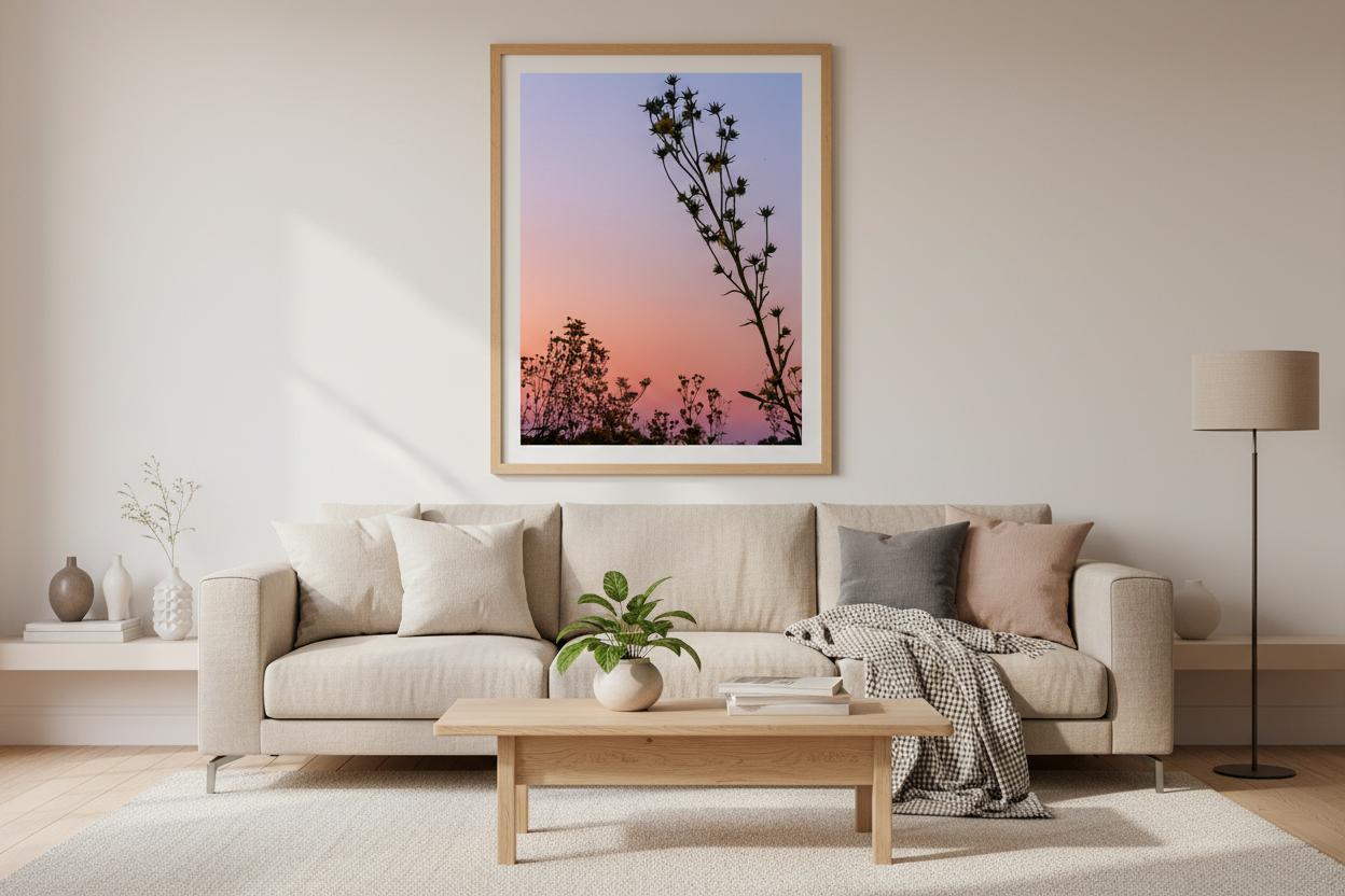 Living room with a beige sofa, wooden coffee table, and framed artwork on the wall.