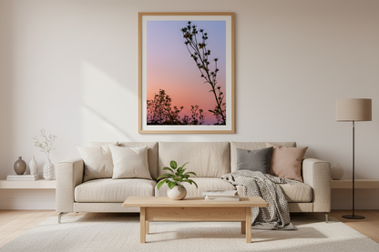 Living room with a beige sofa, wooden coffee table, and framed artwork on the wall.