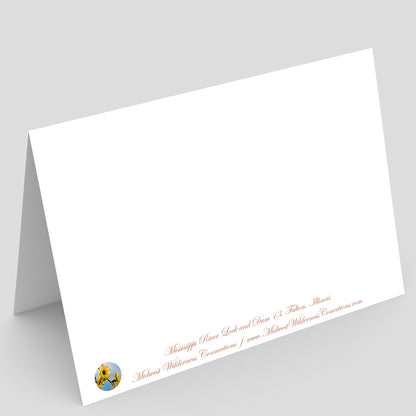 Backside of a White greeting card with red text and a logo on a gray background. The text describes the image on the front of the card and where it was taken.
