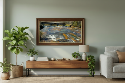 Living room with a framed print of a covered bridge  on the wall, a console table, and a sofa.