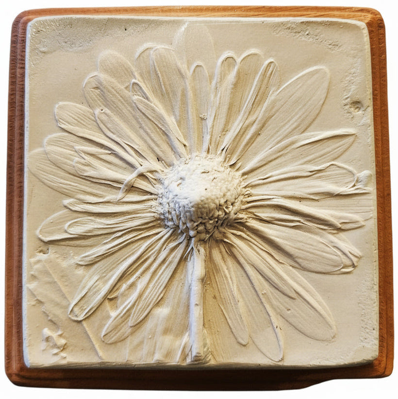 Square plaster cast of flowers mounted on an oak stained wood plaque