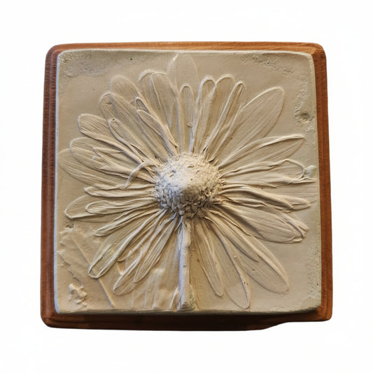 Square plaster cast of flowers mounted on an oak stained wood plaque