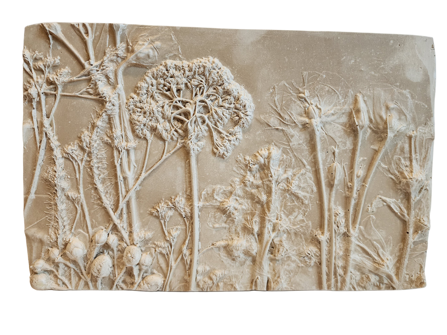 Front view of decorative wall art with bas relief floral design on a beige background.  