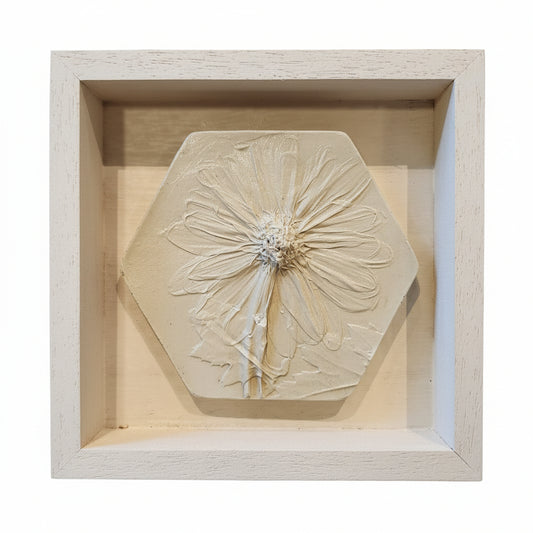 Hexagonal plaster cast of a daisy in a 5"×5"×1" wooden frame in white finish